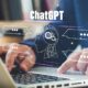 Person using ChatGPT to generate prompts on a computer.
